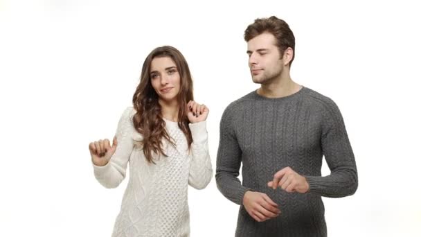 Slow-motion young couple in sweaters enjoy dancing celebrate for christmas fun together feeling attraction. — Stock Video