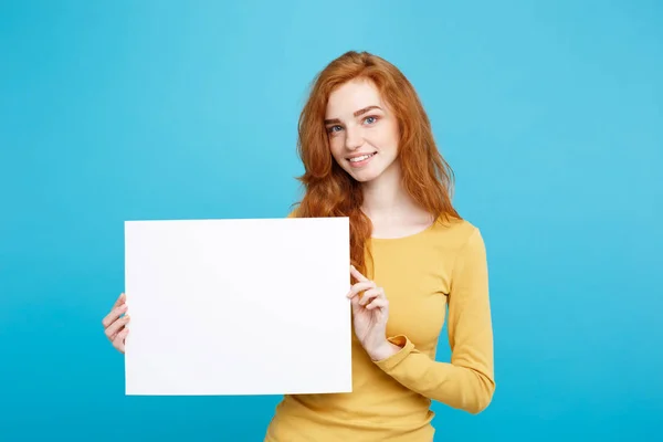 Business Concept - Close up Portrait young beautiful attractive redhair girl smiling showing blank sign. Blue Pastel Background. — Stock Photo, Image