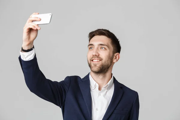 Business Concept - Handsome Business man take a selfie of himself with smartphone. White Background. — Stock Photo, Image