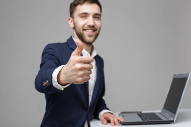 Business Concept - Portrait Handsome Business man showing thump up and smiling confident face in front of his laptop. White Background.Copy Space. clipart