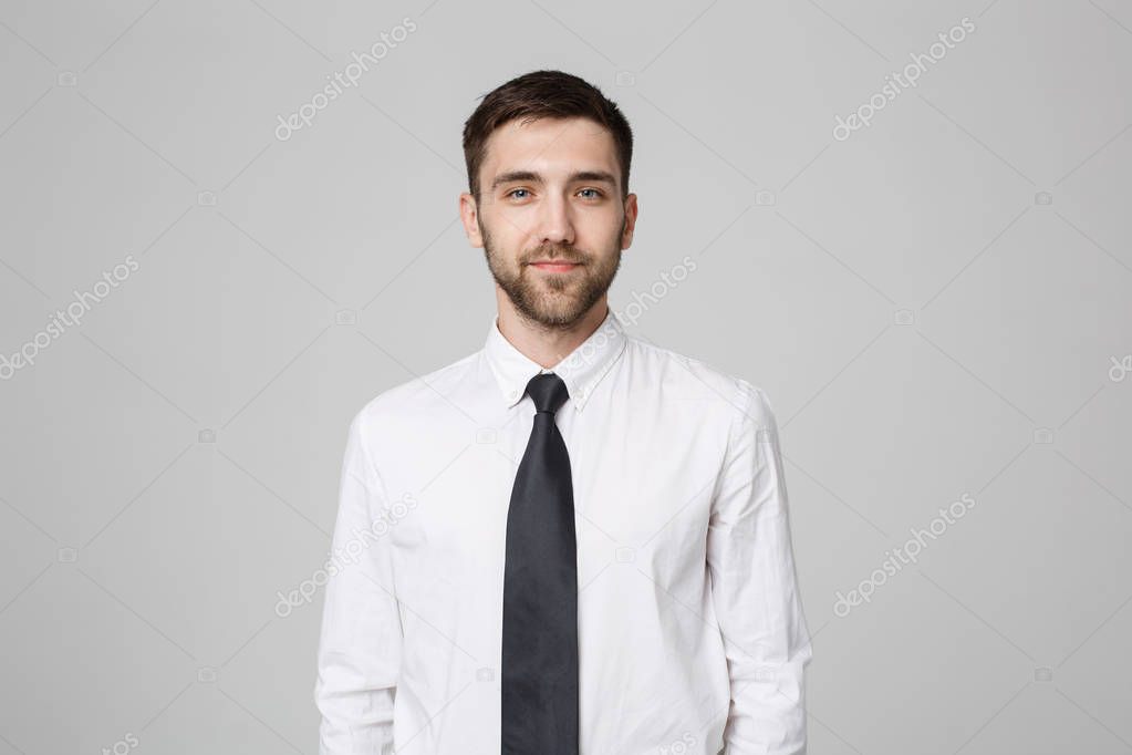 Business Concept - Young successful businessman posing over dark background. Copy space.
