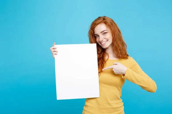 Close up Portrait young beautiful attractive ginger red hair girl smiling showing blank sign. Blue Pastel Background. Copy space. — Stock Photo, Image