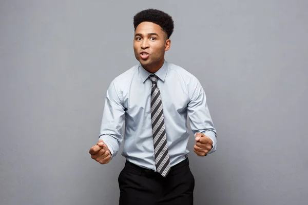 Geschäftskonzept - wütender Afroamerikaner mit verwirrtem Schreien mit frustriertem Gesichtsausdruck vor grauem Hintergrund. — Stockfoto