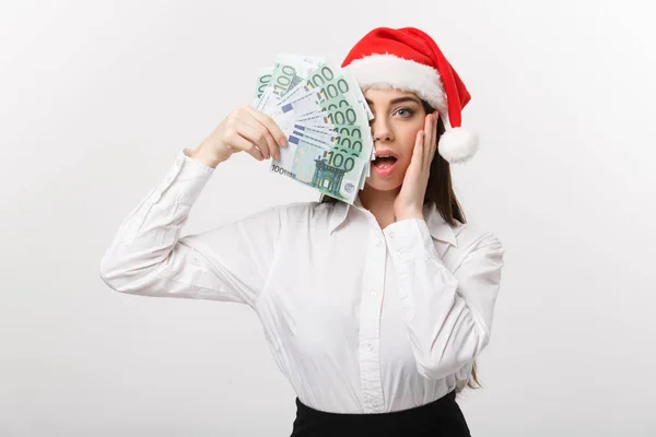 Christmas and finance concept - Young business woman showing money closing her face with surprise expression. — Stock Photo, Image