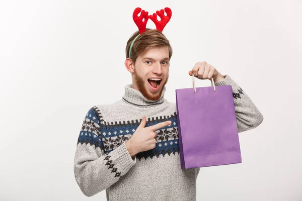 Χριστούγεννα Concept - όμορφος νέος γένια άνθρωπο να χαίρεται με την τσάντα αγορών στο χέρι απομονωθεί σε λευκό. — Φωτογραφία Αρχείου
