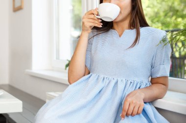 Genç güzel beyaz Bayan zevk içme ve tatlı modern kahve dükkanında öğlen sahip.