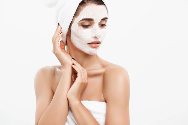 Beauty Skin Care Concept - Beautiful Caucasian Woman Face Portrait applying cream mask on her facial skin white background. — Stock Photo, Image