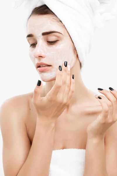 Beauty Skin Care Concept - Beautiful Caucasian Woman Face Portrait applying cream mask on her facial skin white background. — Stock Photo, Image