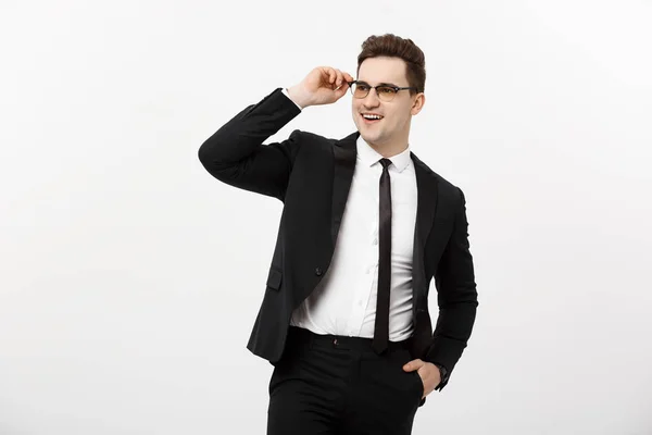 Affärsidé: Ung stilig affärsman glasögon håller handen i fickan isolerad på vit bakgrund. — Stockfoto