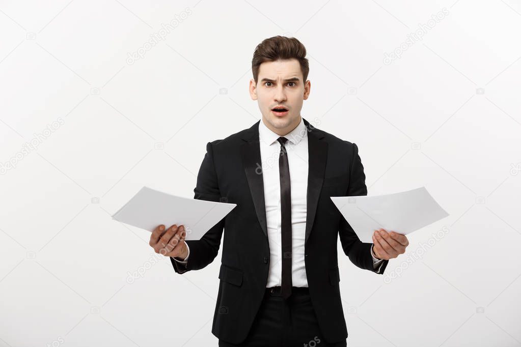 Business, people, paperwork and deadline concept - stressed handsome businessman with papers and charts show shocking facial expression with result