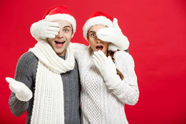Christmas Concept - Young happy stylish couple in winter clothes close eyes each other celebrating in Christmas day — стоковое фото