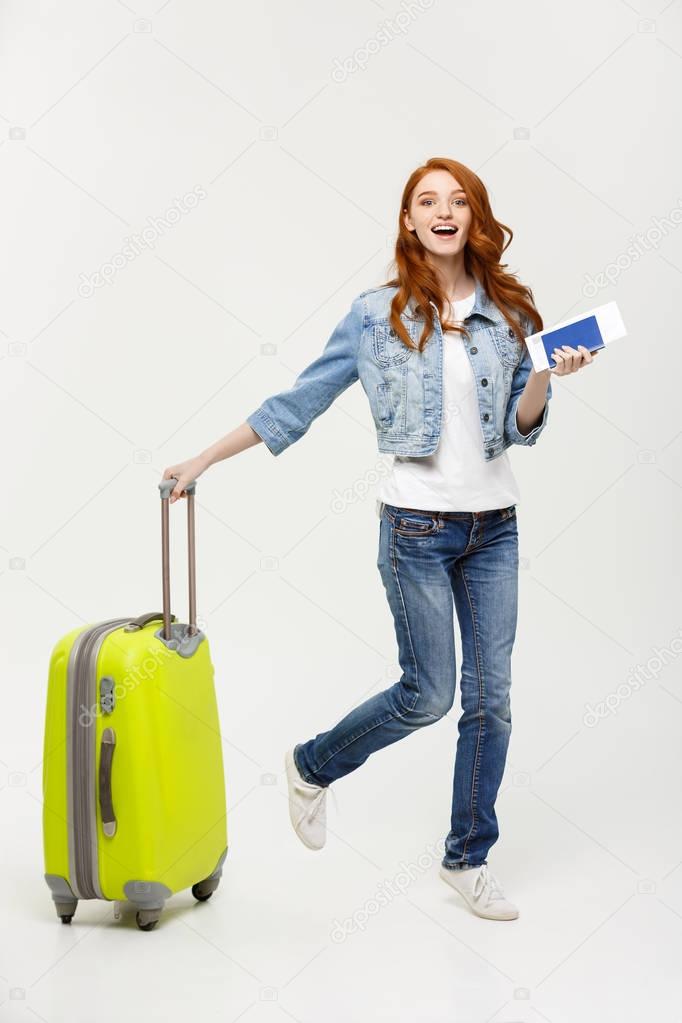 Travel and Lifestyle Concept: young woman with suitcase ready for summer travel isolated on white