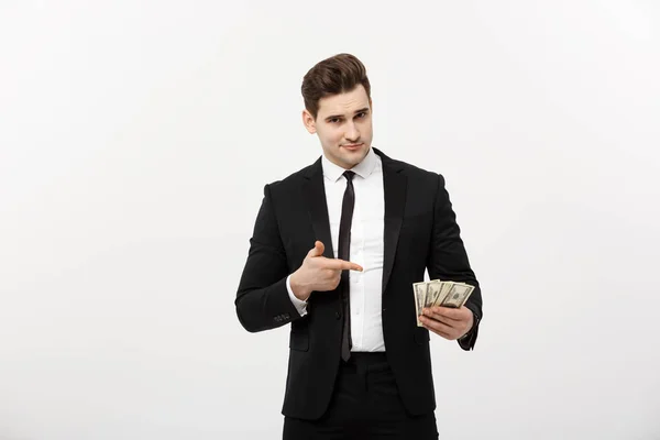 Бизнесмен в костюме, указывающий пальцем на деньги. Изолированный на белом фоне . — стоковое фото