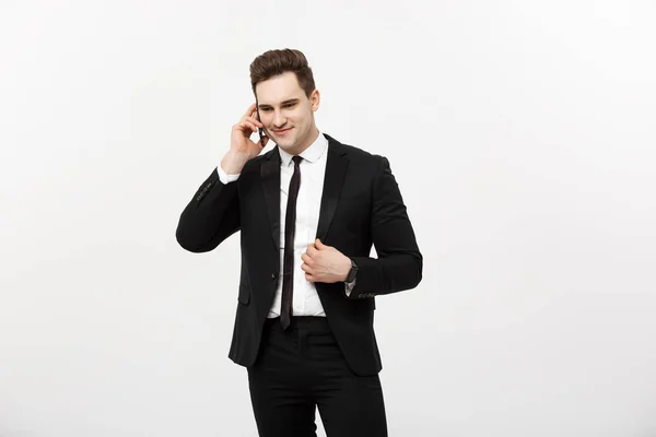 Handsome businessman in suit speaking on the phone over isolated white background. — Stock Photo, Image