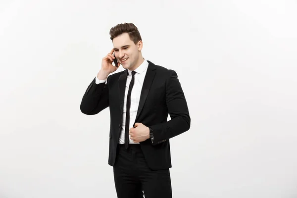 Handsome businessman in suit speaking on the phone over isolated white background. — Stock Photo, Image