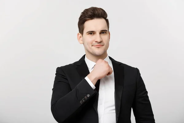 Business Concept: Sorridente uomo bello in piedi su sfondo bianco isolato e toccare il mento con mano — Foto Stock