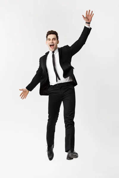Business Concept: Full-length Ritratto eccitato bell'uomo d'affari con le braccia sollevate nel successo. Isolato su sfondo grigio . — Foto Stock