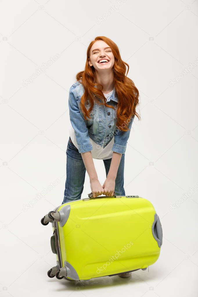 Travel and Lifestyle Concept: Young happy beautiful woman holding green suitcase over white background