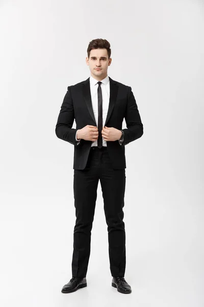 Business Concept: Handsome Man Happy Smile Young Handsome Guy in smart suit posing over Isolated Grey Background. — Stock Photo, Image