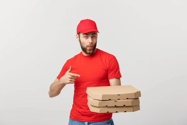 Conceito de entrega: Bonito caucasiano Entrega de pizza homem apontando dedo. Isolado sobre fundo cinza . — Fotografia de Stock
