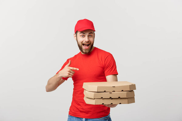 Delivery Concept: Handsome caucasian Pizza delivery man pointing finger. Isolated over grey background.