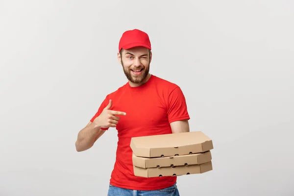 Leverans koncept: Stilig kaukasiska Pizzaleverans mannen pekande finger. Isolerade över grå bakgrund. — Stockfoto