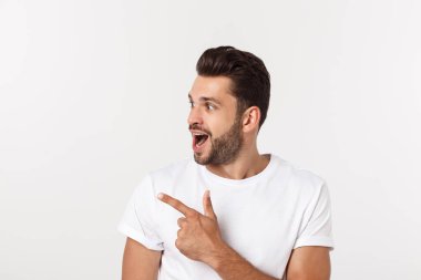 Beyaz arkaplanda kopyalama alanı gösteren bir adam var. Sıradan yakışıklı Kafkasyalı genç adam..