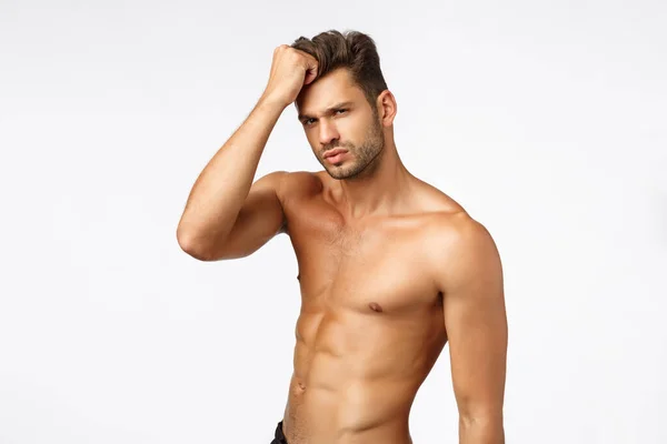Advertisement, beauty and masculinity concept. Handsome, sassy and sexy young man promote healthy lifestyle, workout, bodybuilding or beauty haircare products, stand naked torso, touching haircut — Stock Photo, Image