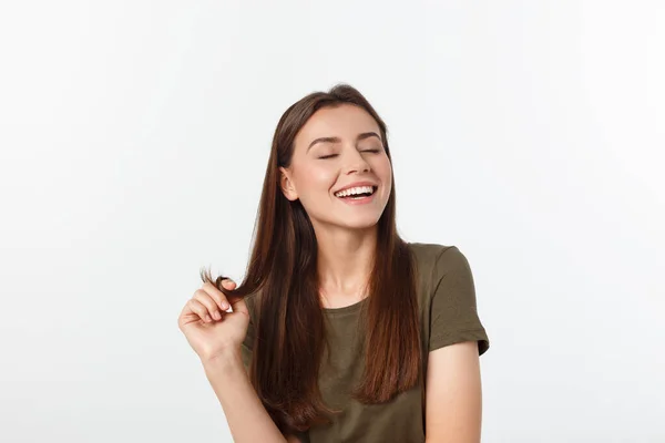 amazement - woman excited looking to the side. Surprised happy young woman looking sideways in excitement. Mixed race Asian and white Caucasian female model on grey background.