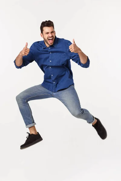 Portrait of a satisfied young caucasian man celebrating success isolated over white background. — Stock Photo, Image