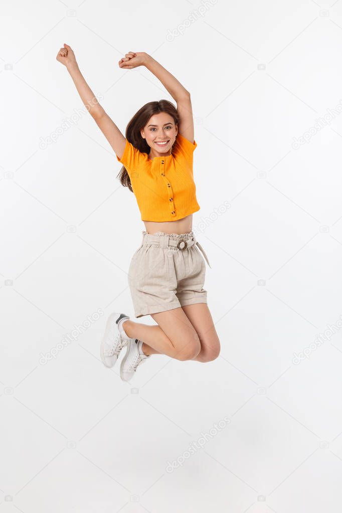 Cool hipster portrait of young stylish teen girl showing her hands up, positive mood and emotions,travel alone. Isolated over grey background