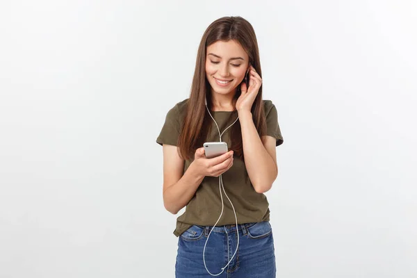 Retrato de una linda mujer alegre escuchando música en auriculares y bailando aislada sobre un fondo blanco . — Foto de Stock