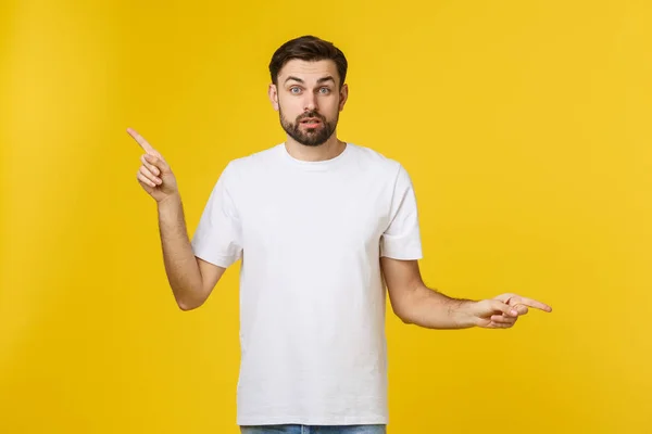 Handsome man over isolated yellow wall frustrated and pointing to the front. — Stock Photo, Image