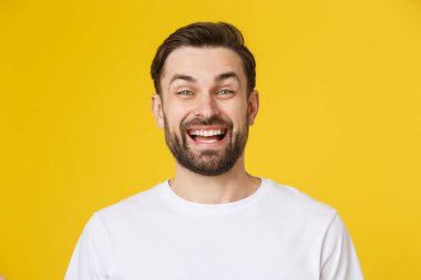 Sarı arka planda izole edilmiş genç adam portresi