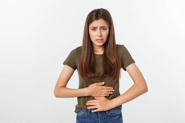 Young beautiful asian woman having painful stomachache on white background. — Stock Photo, Image