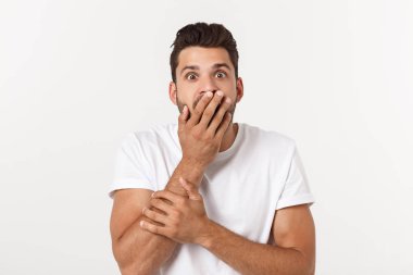 Beyaz arka plan üzerinde izole şok yüz ifadesi ile genç adam portresi.