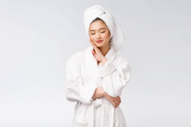 Bornozlu mutlu bir Asyalı kadının portresi. Beyaz arka planda izole edilmiş..