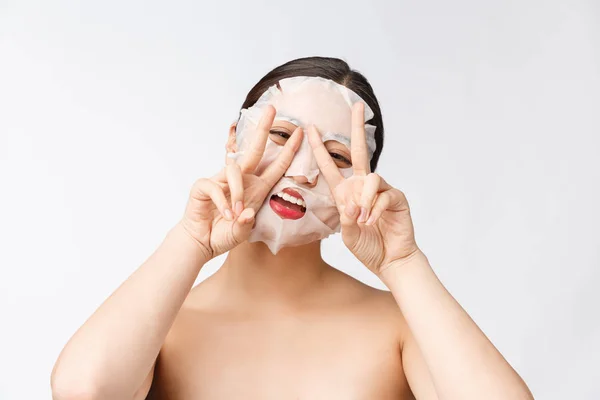 Spa, healthcare. Woman with purifying mask on her face isolated on white background. — Stock Photo, Image
