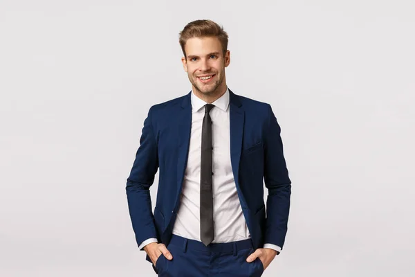 Handsome confident blond bearded businessman, holding hands in pockets, smiling joyfully, give professional vibe, discussing business, double his income, become successful, white background — Stock Photo, Image