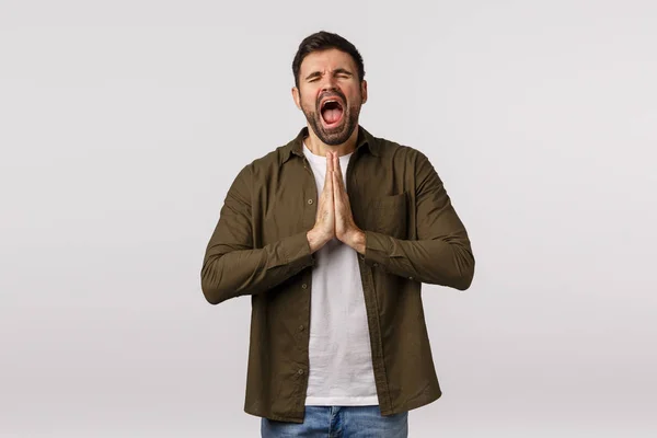 Please forgive me im begging you. Miserable and upset, sad bearded man crying and beg apology, close eyes press palms together in pray gesture, supplicating, being sad and frustrated — Stock Photo, Image