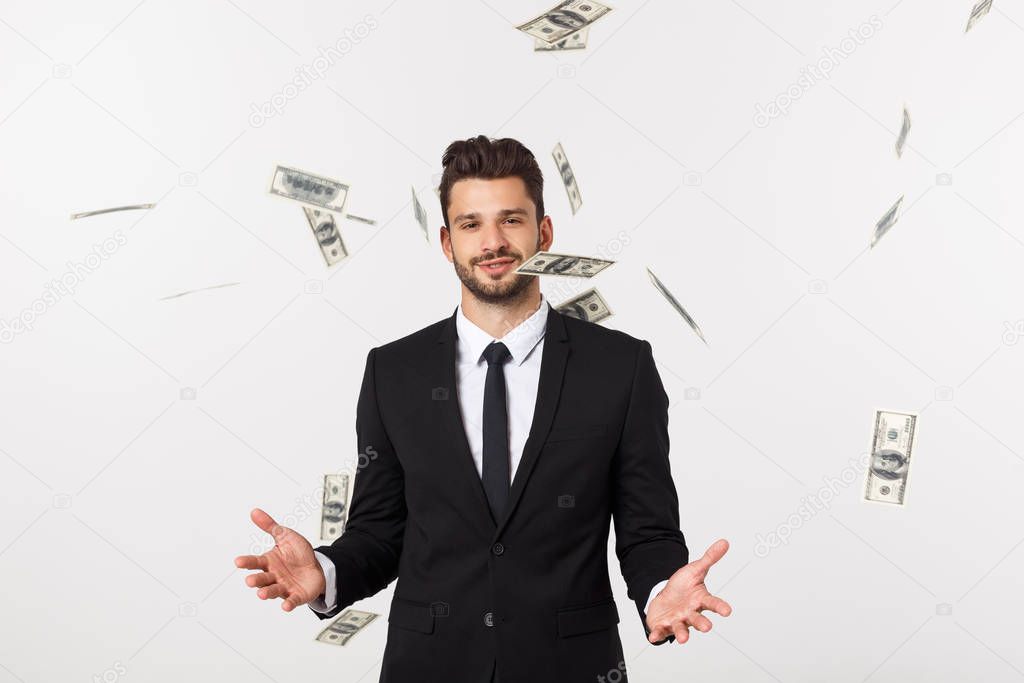 Portrait of a satisfied young businessman holding bunch of money banknotes isolated over white background.