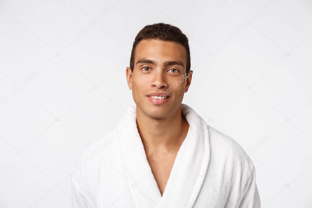 African American guy wearing a bathrobe with happy emotion. Isolated over whtie background.