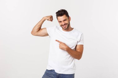 Yakışıklı, yakışıklı, komik, sakallı adam pazılarını gösteriyor ve beyaz arka planda gülümsüyor.