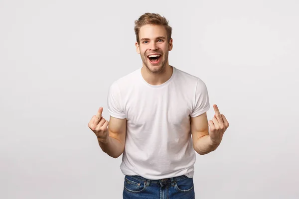 Rude and expressive, intollerant blond happy careless guy, dont care people opinion, fuck-off, showing middle fingers and cursing with smile on face, feeling daring and sassy, white background — Stock Photo, Image