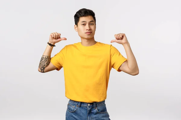 Arrogant and self-assured, stylish asian macho man in yellow t-shirt, thinking he is awesome sexy and cool, pointing himself smirk confident and assertive, volunteer, want you pick him — 스톡 사진