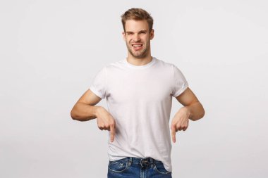 Hoşnutsuz, tiksindirici, yakışıklı, sarı saçlı, kıllı, hoşlanmamaktan ve isteksizlikten gözlerini kısarak bakan, nefreti işaret eden, kuşkucu, kötü kokulu, beyaz arkaplan...