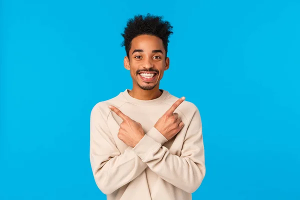 Handsome cheerful boyfriend cant wait celebrate holidays, asking friend opinion about two choices of gift, pointing sideways unsure, making decision, showing left and right products, smiling — 스톡 사진