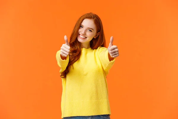 Good luck. Optimistic, confident cute redhead girlfriend encourage you, giving thumbs-up in like or approval, smiling rate excellent movie or product, give positive feedback, recomment, orange wall — 스톡 사진