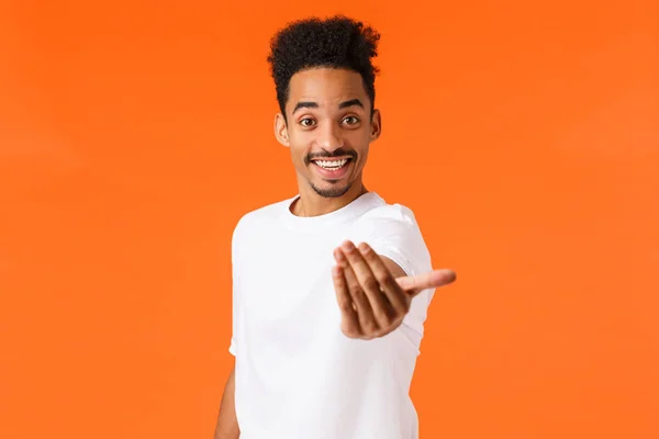 Come on join us. Happy and friendly outgoing african-american modern male student inviting participate, hiring, make come here gesture and smiling, lure, standing orange background — Stock Photo, Image