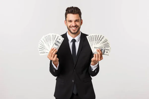 Retrato de un joven empresario satisfecho sosteniendo un montón de billetes de dinero aislados sobre fondo blanco . — Foto de Stock